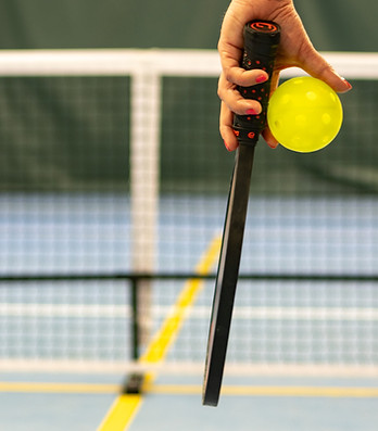 a person holding a tennis ball and a racket_edited.jpg